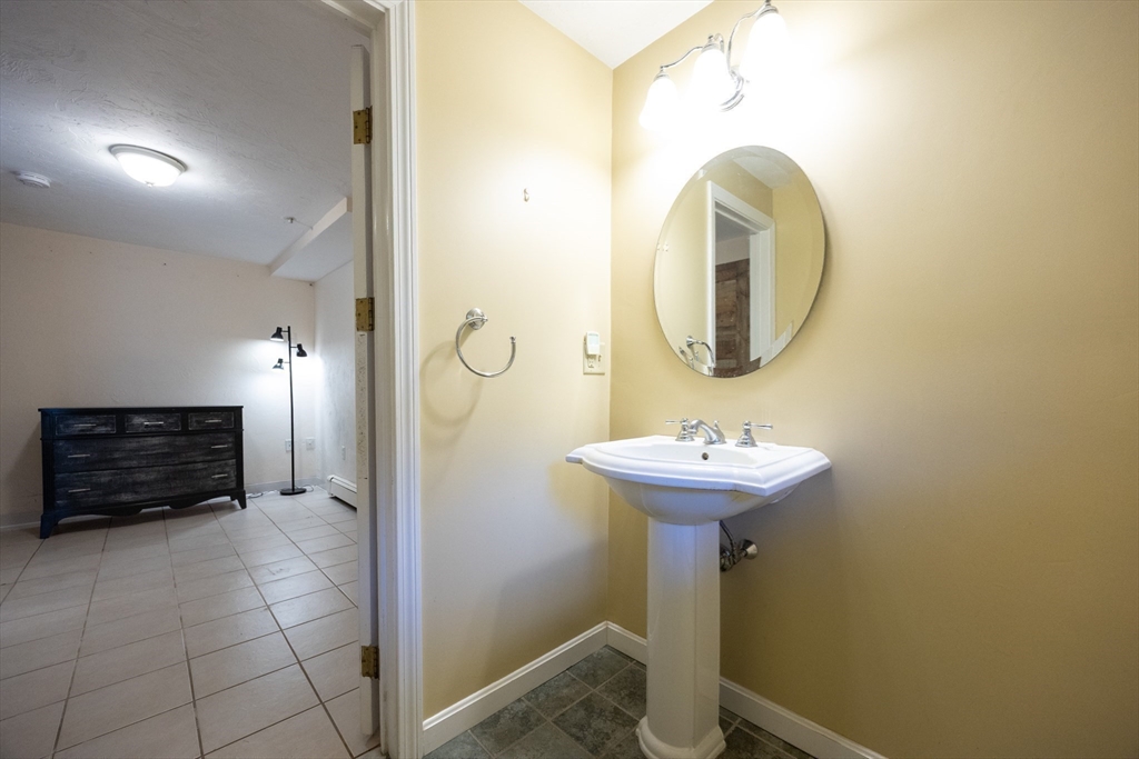 27 Fowler Street Upton, MA 01568 - Photo 31 of 36 a bathroom with a sink a mirror and a shower