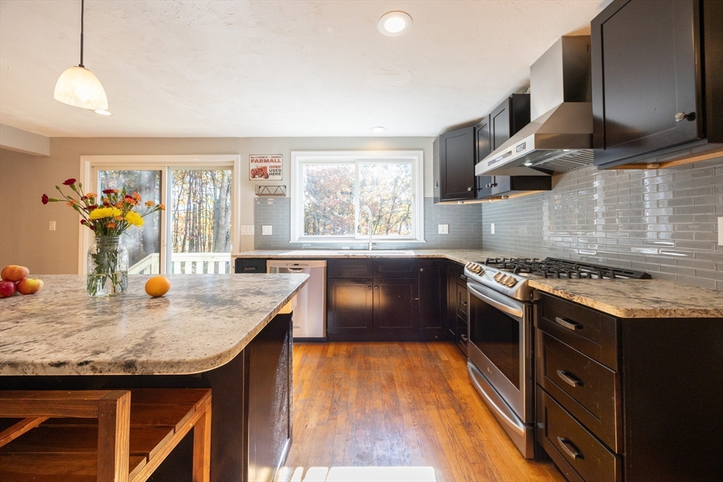 27 Fowler Street Upton, MA 01568 - Photo 4 of 36 a kitchen with granite countertop a stove and a sink