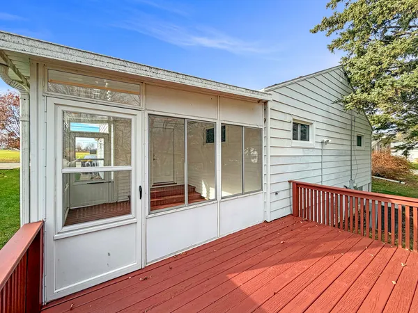 a view of a house with a wooden deck