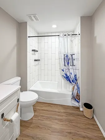 a bathroom with a toilet and a shower