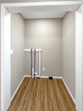 a view of a room with wooden floor and fence