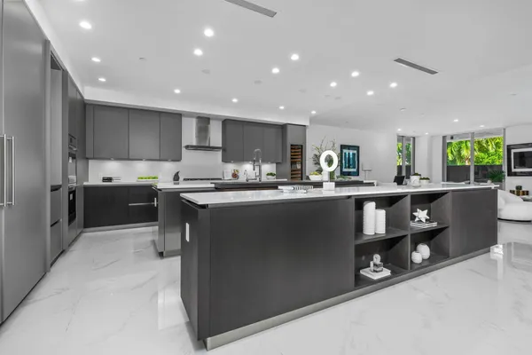 a kitchen with stainless steel appliances granite countertop a stove a sink a refrigerator and a oven