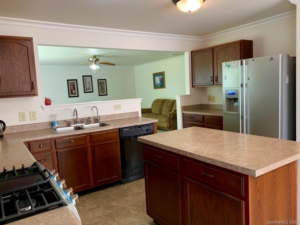 2517 Spring Breeze Way Monroe, NC 28110 - Photo 14 of 39 a kitchen with a sink appliances and cabinets