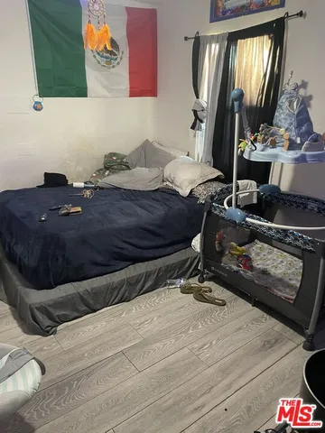 a bedroom with a bed and dresser with mirror