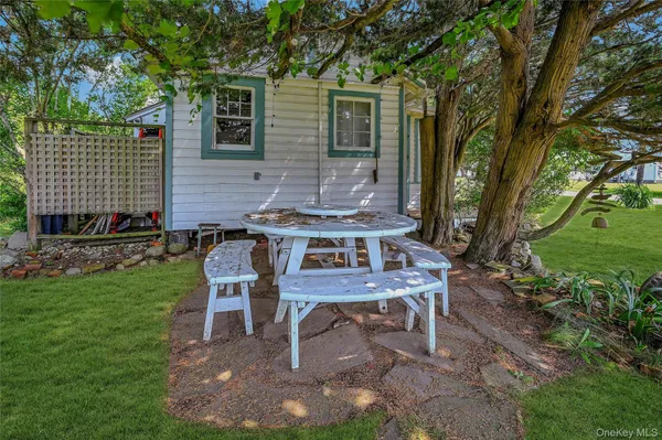 a wooden bench sitting in front of a house