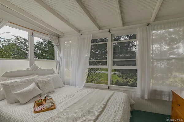 a bed sitting in a bedroom next to a window