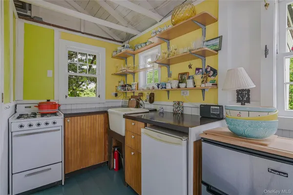 a kitchen with a sink and a stove top oven