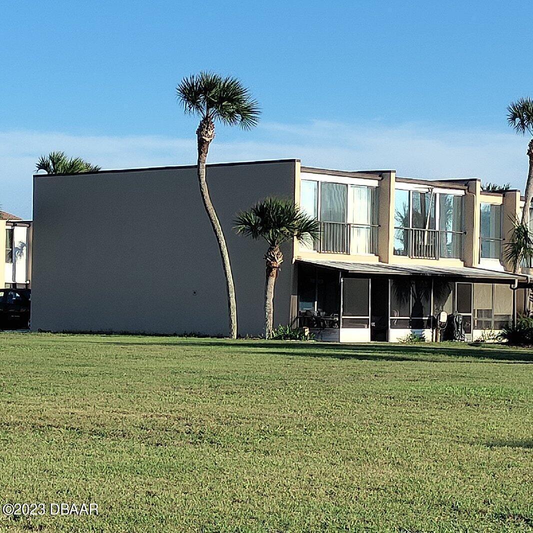 5500 Ocean Shore Boulevard, Unit 41 Ormond Beach, FL 32176 - Photo 1 of 9 a front view of building with yard