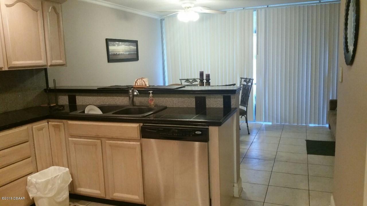 5500 Ocean Shore Boulevard, Unit 41 Ormond Beach, FL 32176 - Photo 3 of 9 a kitchen with a sink and cabinets