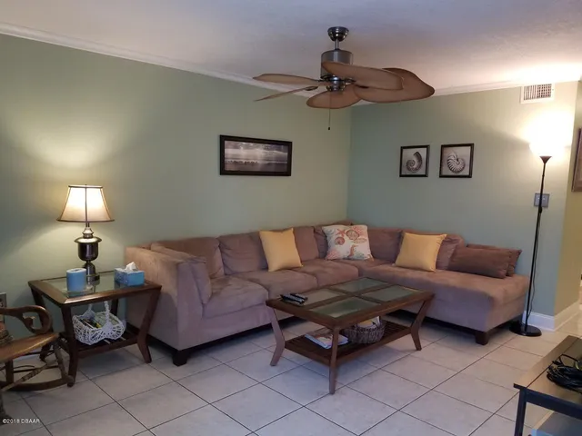 a living room with furniture and a lamp