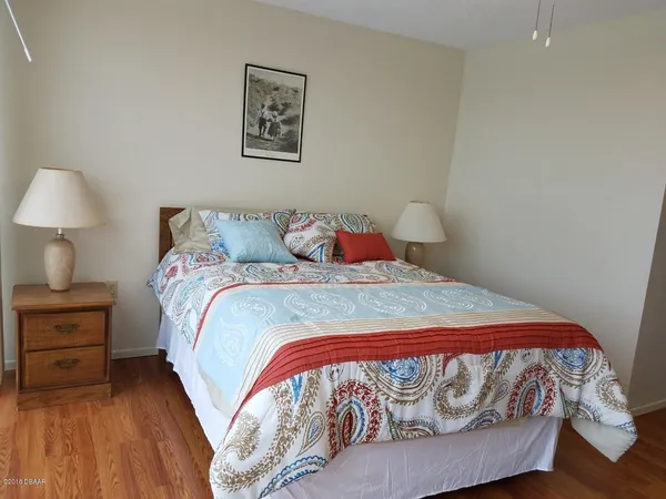 a bedroom with a bed and a lamp