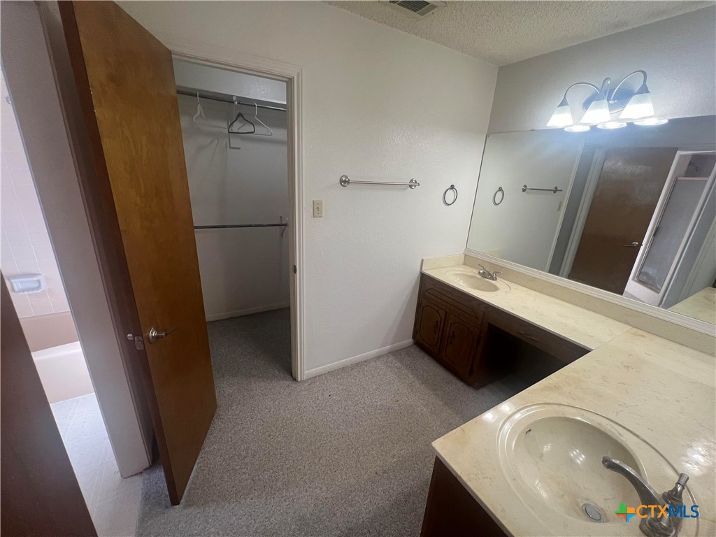 20239 Stillman Valley Road Florence, TX 76527 - Photo 16 of 35 a view of a storage and utility room with washer and dryer