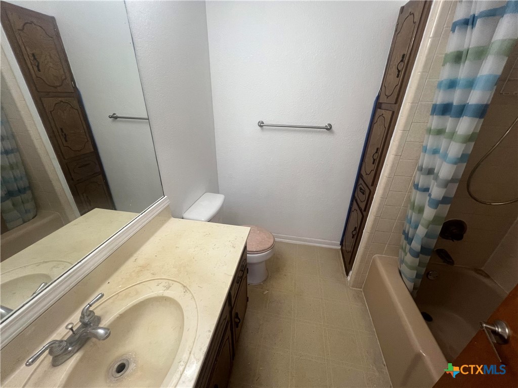 20239 Stillman Valley Road Florence, TX 76527 - Photo 17 of 35 a bathroom with a sink and toilet