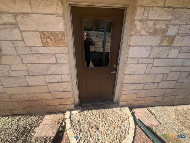 a view of a livingroom with furniture and a floor to ceiling window