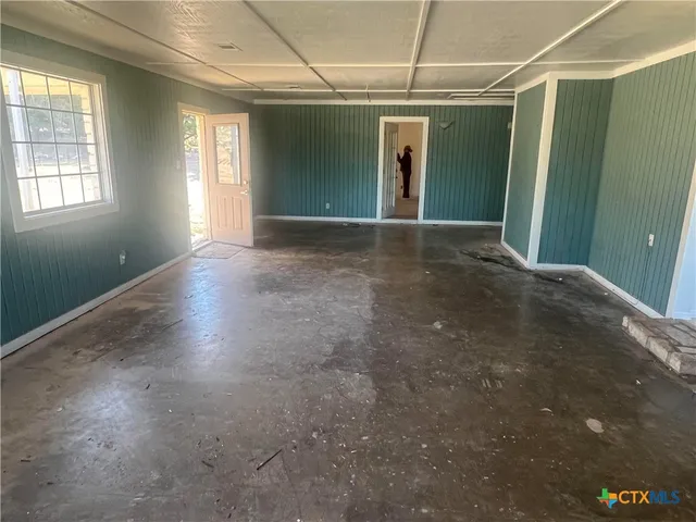 a view of a livingroom with furniture hardwood floor and windows