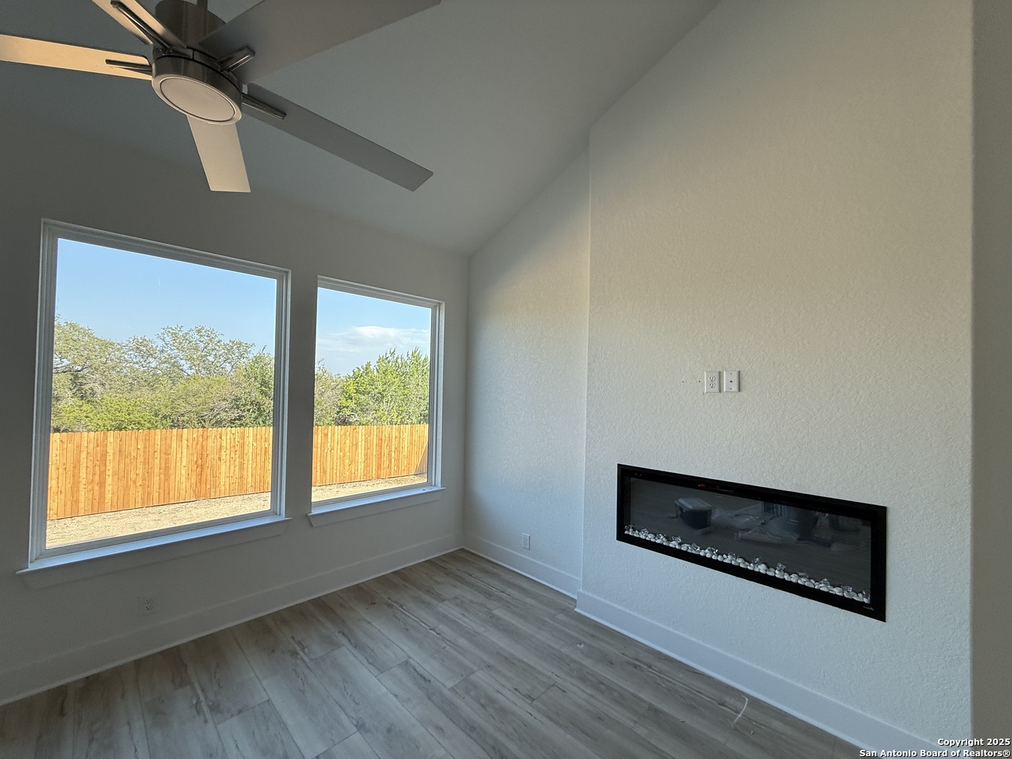 423 Glenwood Ranch Cibolo, TX 78108 - Photo 6 of 33 a view of an empty room with wooden floor and a window