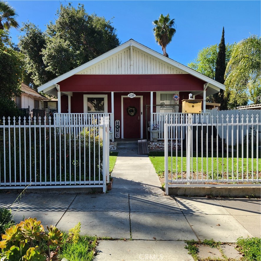 a view of a house with a small yard and flower plants