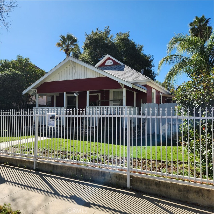 4280 9th Street Riverside, CA 92501 - Photo 2 of 11 a view of a house with a small yard and wooden fence