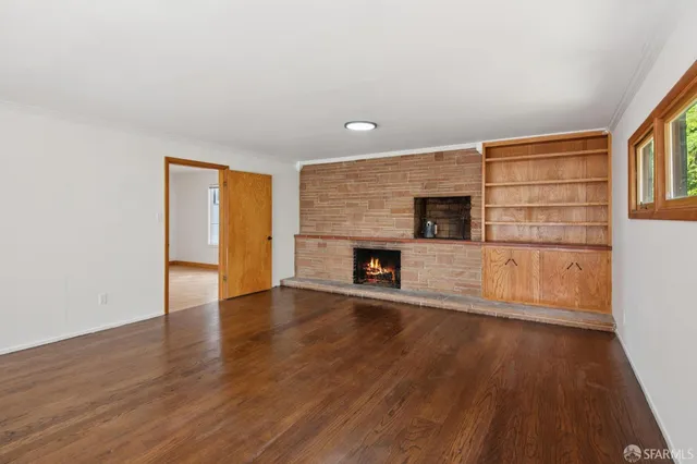 a view of wooden floor and windows in a room