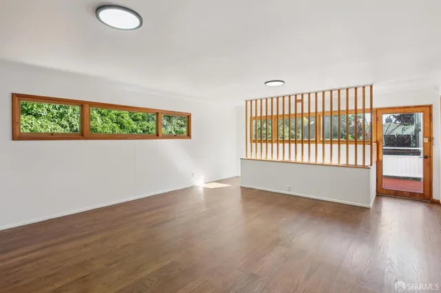 an empty room with windows and closet