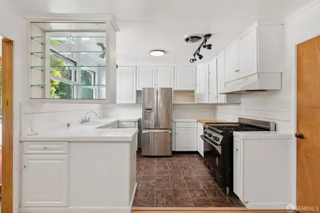 a kitchen with cabinets and stainless steel appliances
