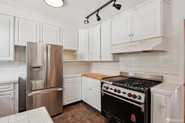 a kitchen with cabinets and stainless steel appliances