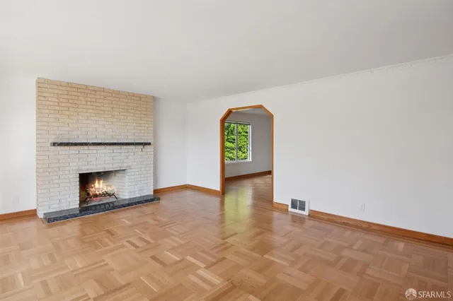 a view of empty room with a fireplace