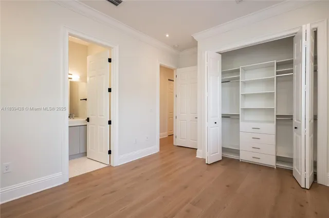 a bathroom with a tub a double vanity sink a large mirror and a bathtub