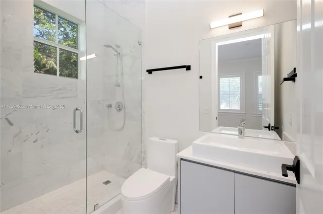 a large bathroom with a tub sink shower and a mirror