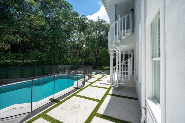 a view of a balcony with a floor to ceiling window and wooden fence