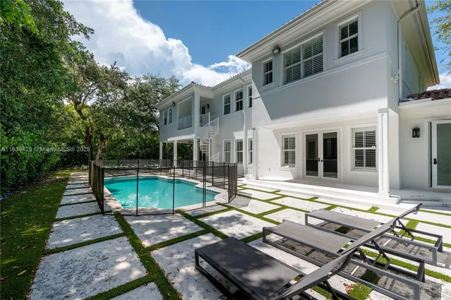 a view of a patio with lawn chairs wooden floor and fence