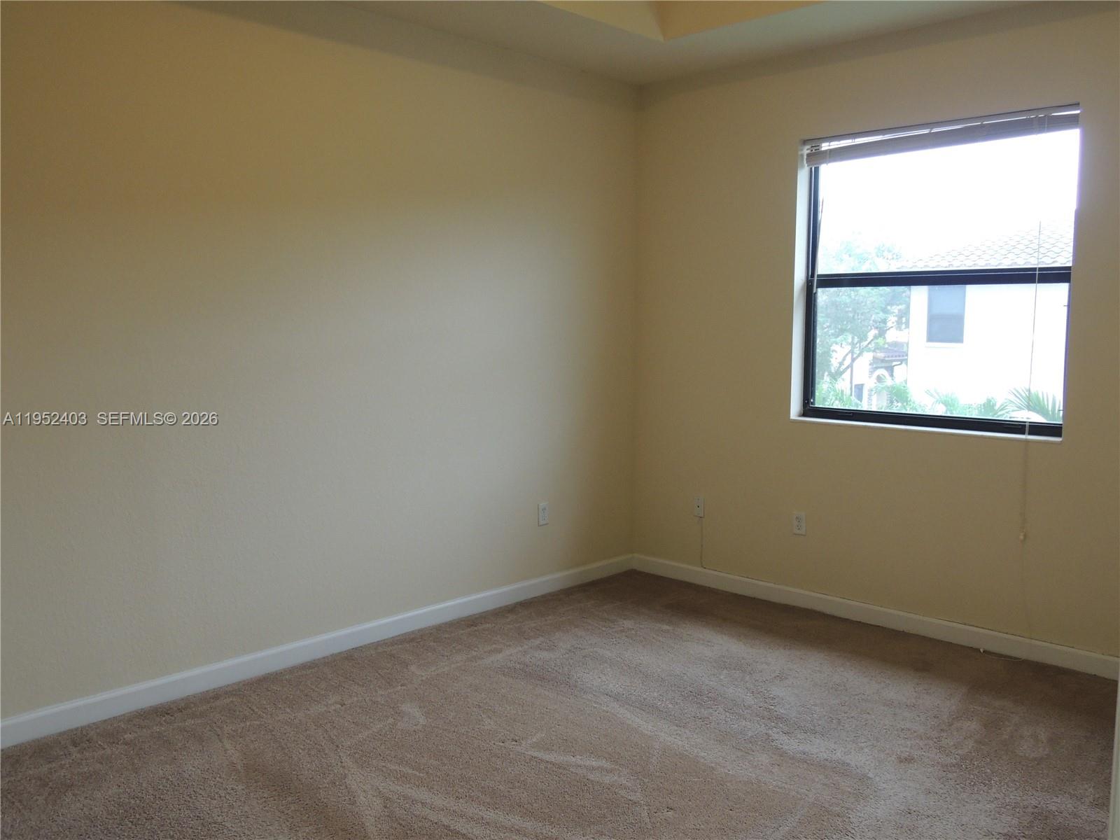 3344 West 91st Terrace, Unit 3344 Hialeah, FL 33018 - Photo 13 of 22 an empty room with a window