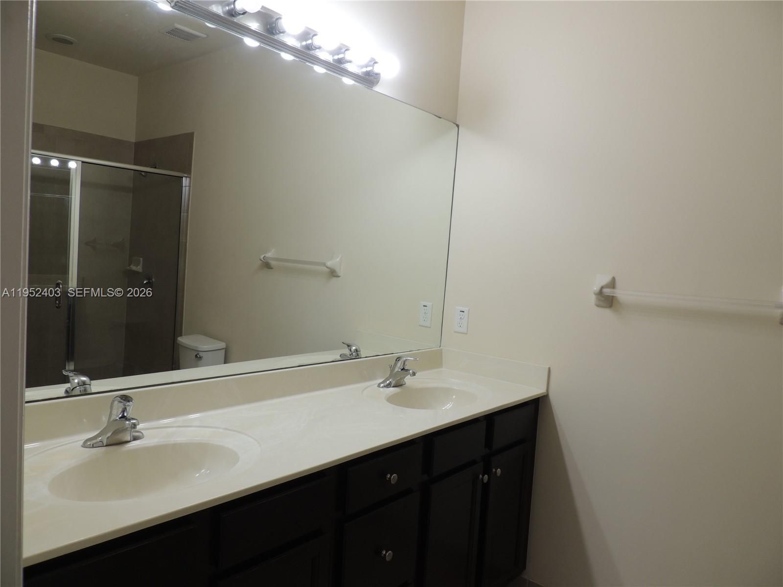 3344 West 91st Terrace, Unit 3344 Hialeah, FL 33018 - Photo 15 of 22 a bathroom with a sink and a mirror