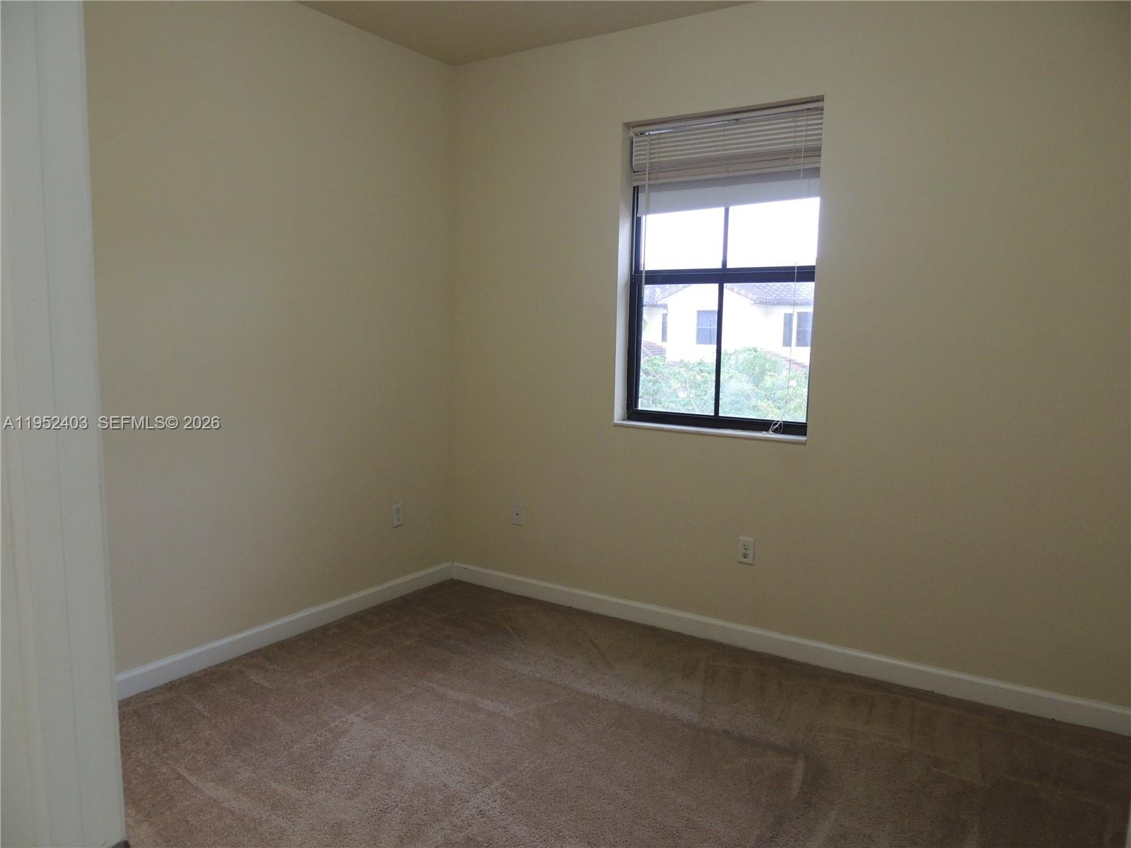 3344 West 91st Terrace, Unit 3344 Hialeah, FL 33018 - Photo 17 of 22 an empty room with a window