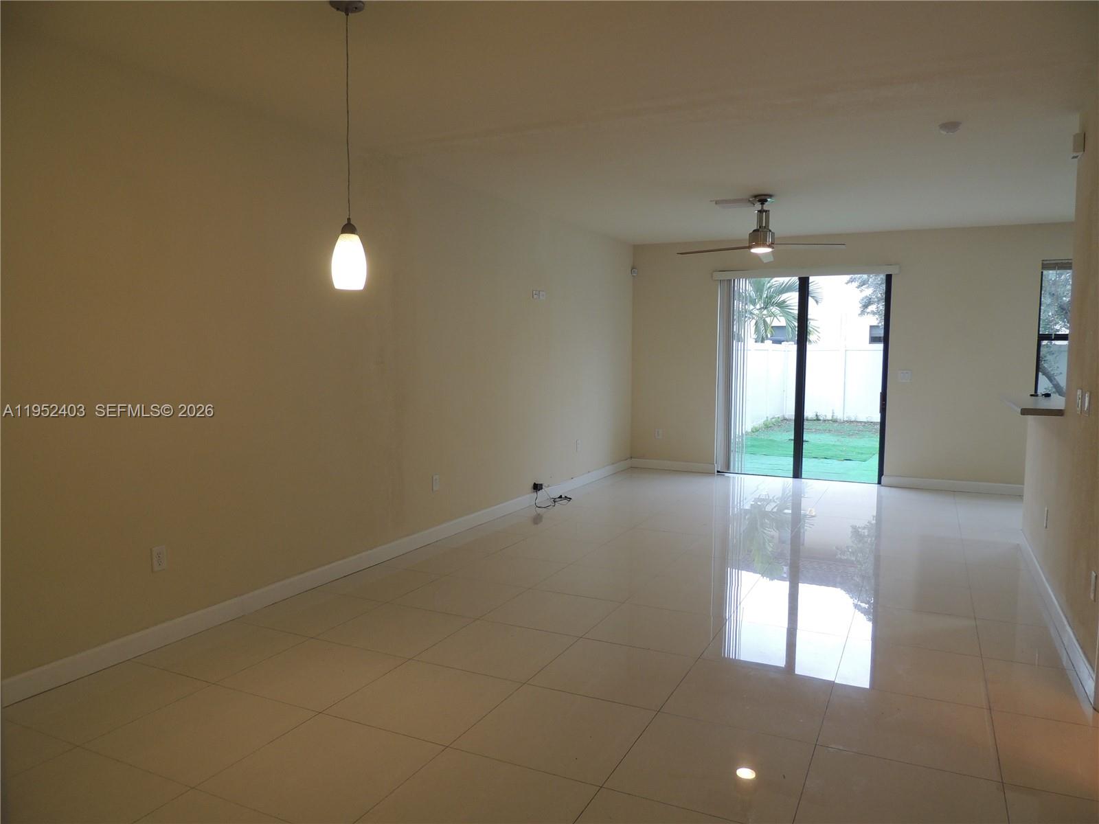 3344 West 91st Terrace, Unit 3344 Hialeah, FL 33018 - Photo 5 of 22 a view of an empty room with a window