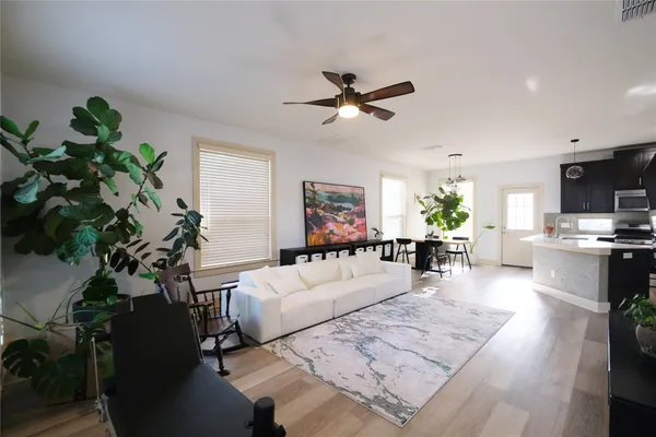 a living room with furniture and a potted plant