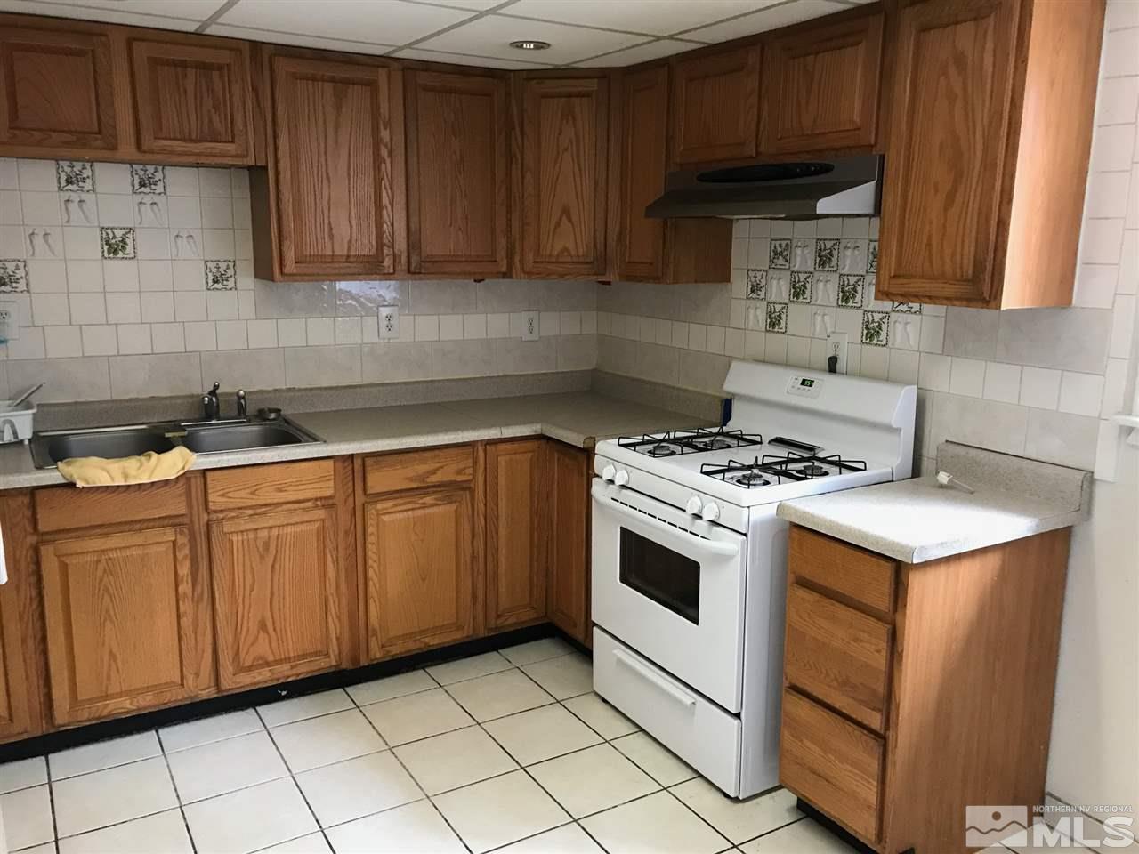 1845 Trainer Way Reno, NV 89512 - Photo 2 of 11 a kitchen with granite countertop cabinets and white stove