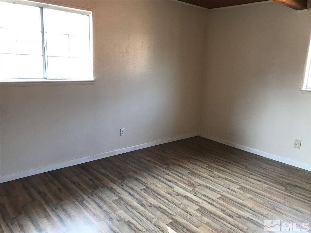 1845 Trainer Way Reno, NV 89512 - Photo 5 of 11 a view of an empty room with wooden floor and a window