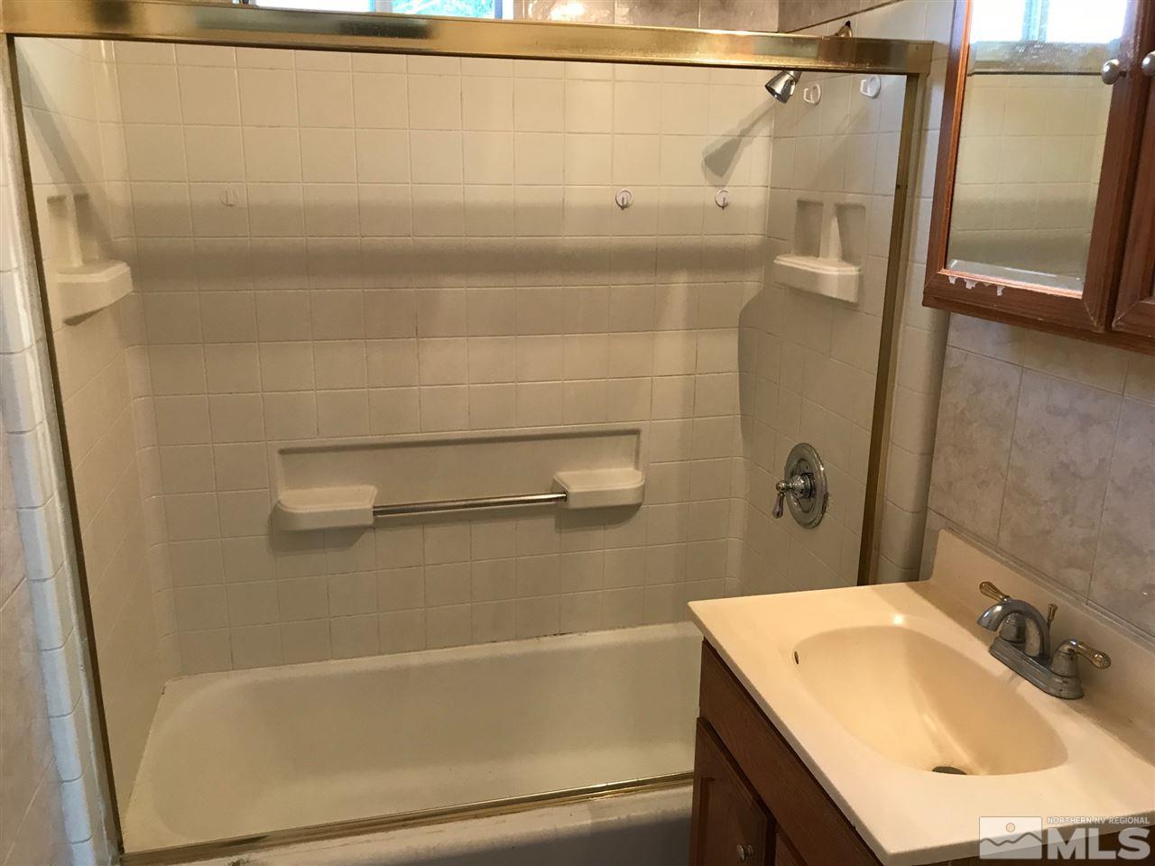 1845 Trainer Way Reno, NV 89512 - Photo 7 of 11 a bathroom with a sink a mirror and a shower