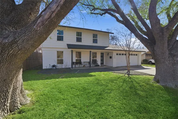 a view of house with a yard