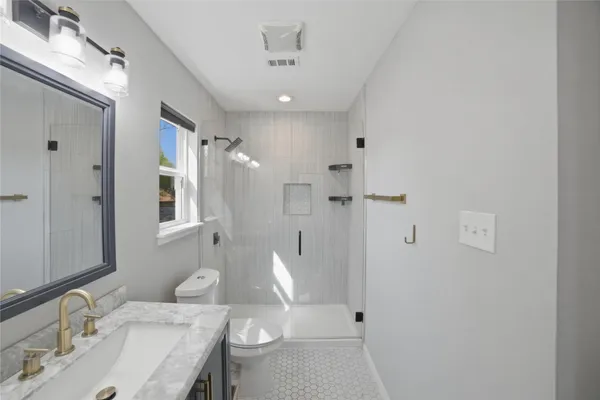 a bathroom with a sink toilet and shower