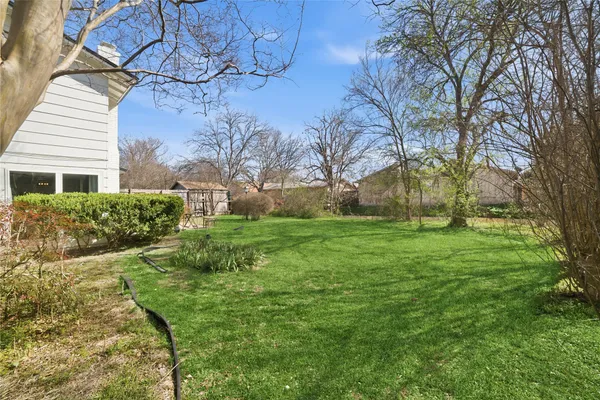 a view of backyard with garden and trees