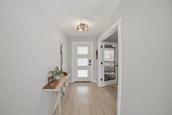 a view of an entryway with wooden floor