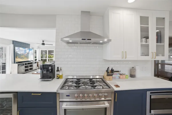 a kitchen with a stove and cabinets