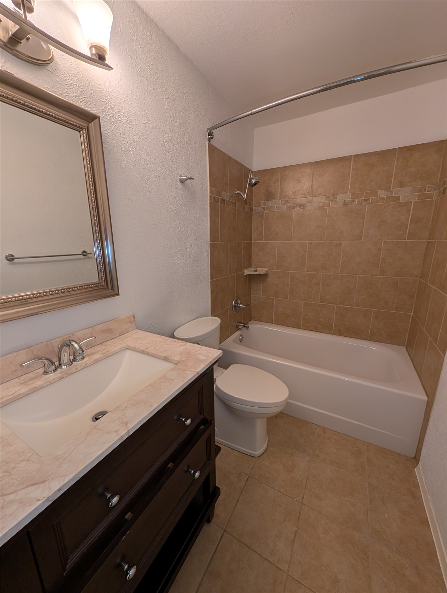 4601 Tamarack Trail Austin, TX 78727 - Photo 12 of 19 A well-appointed bath boasts tiled floors and a convenient vanity with ample storage.