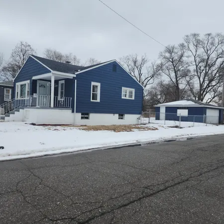 a view of house with snow on the road