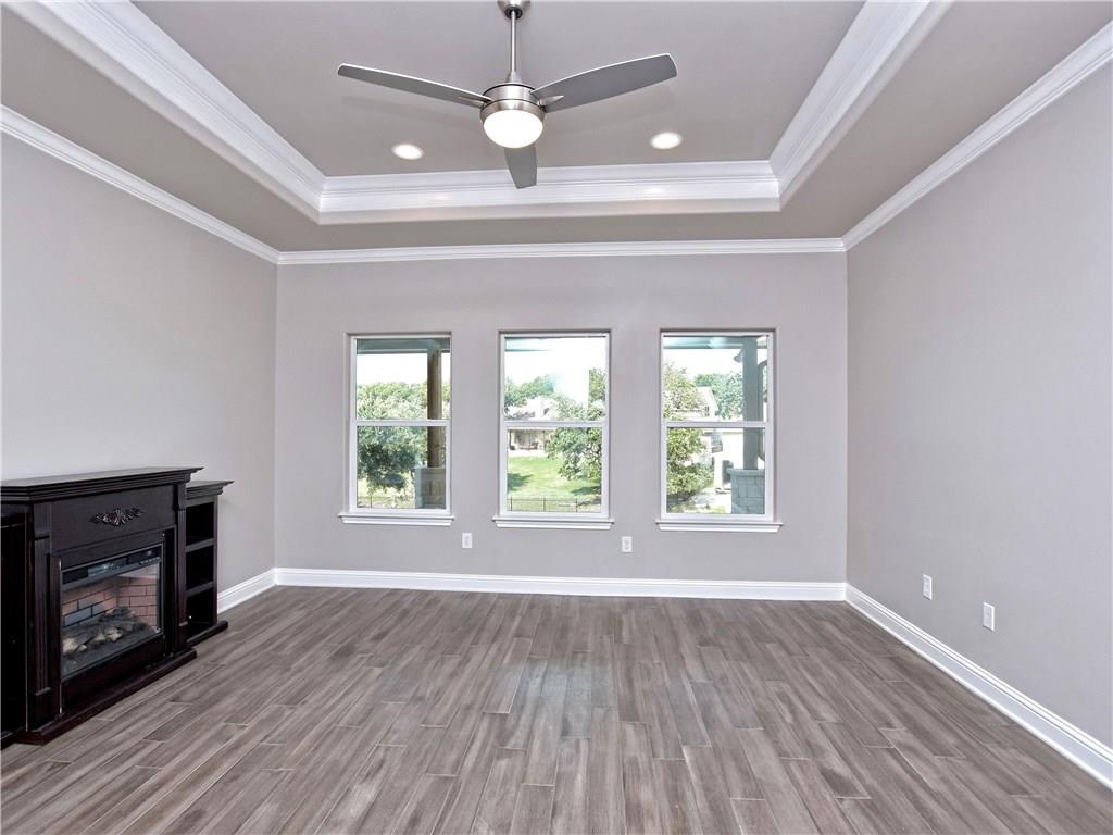 133 Tuscany Way Georgetown, TX 78633 - Photo 16 of 30 a view of an empty room with wooden floor fireplace and a window