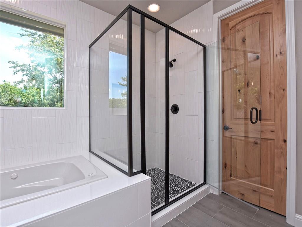 133 Tuscany Way Georgetown, TX 78633 - Photo 19 of 30 a bathroom with a bathtub and a shower