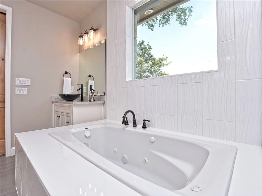 133 Tuscany Way Georgetown, TX 78633 - Photo 23 of 30 a bathroom with a sink and a large mirror