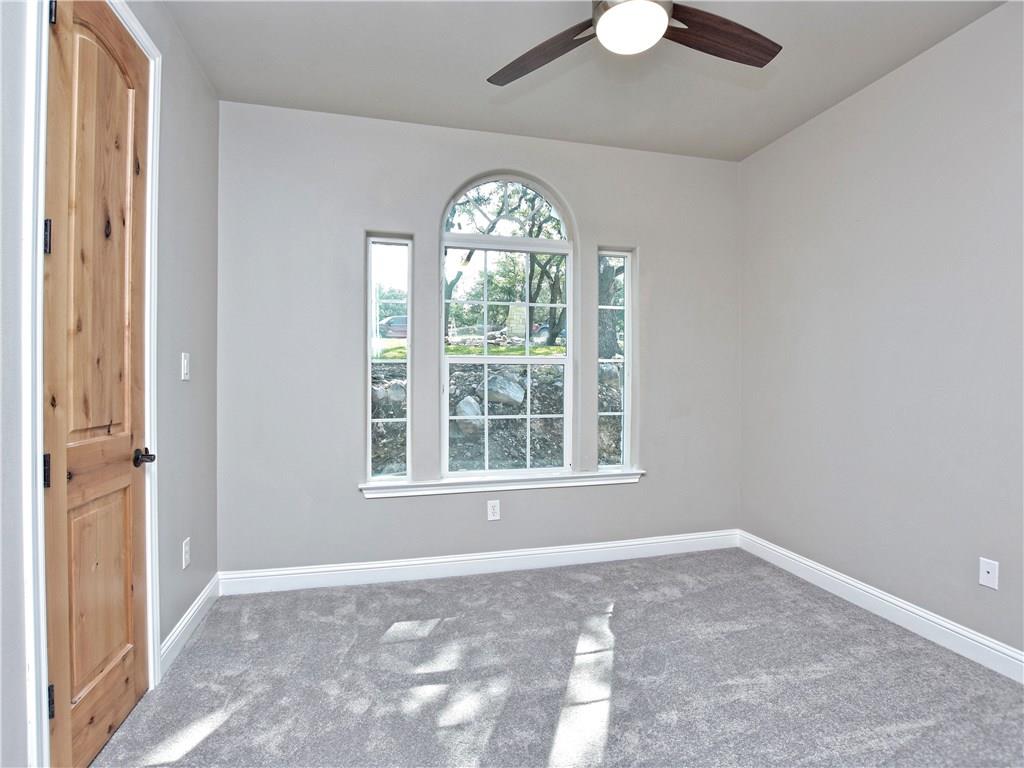 133 Tuscany Way Georgetown, TX 78633 - Photo 24 of 30 an empty room with chandelier fan and windows